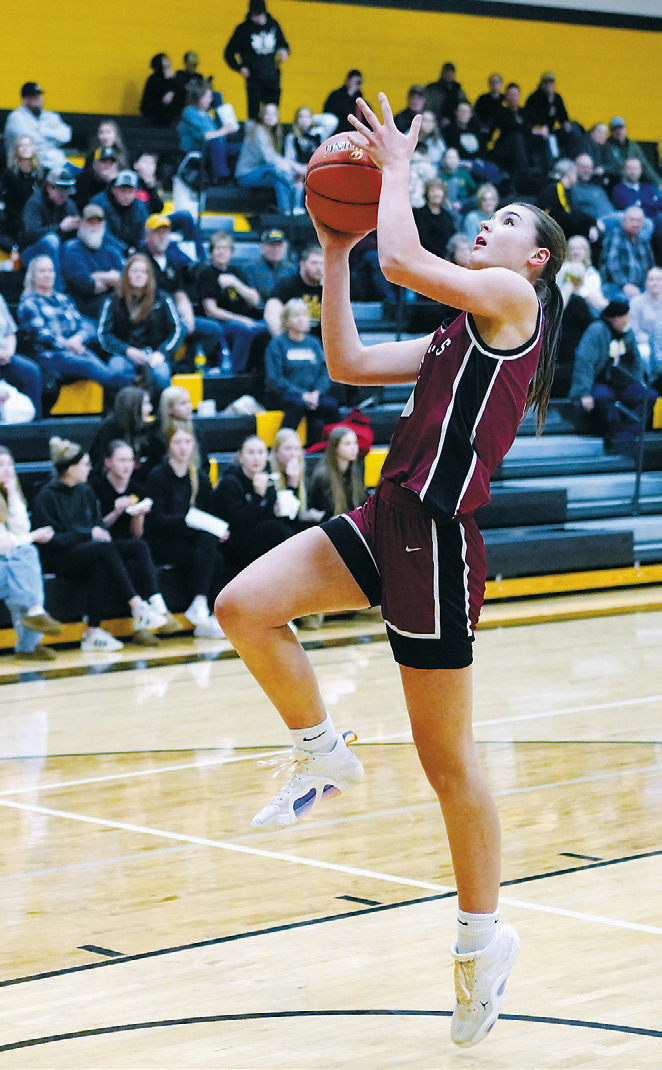 Taya Feist fast breaks and adds two points to the Cards' score. Photo by Larry Stokke.