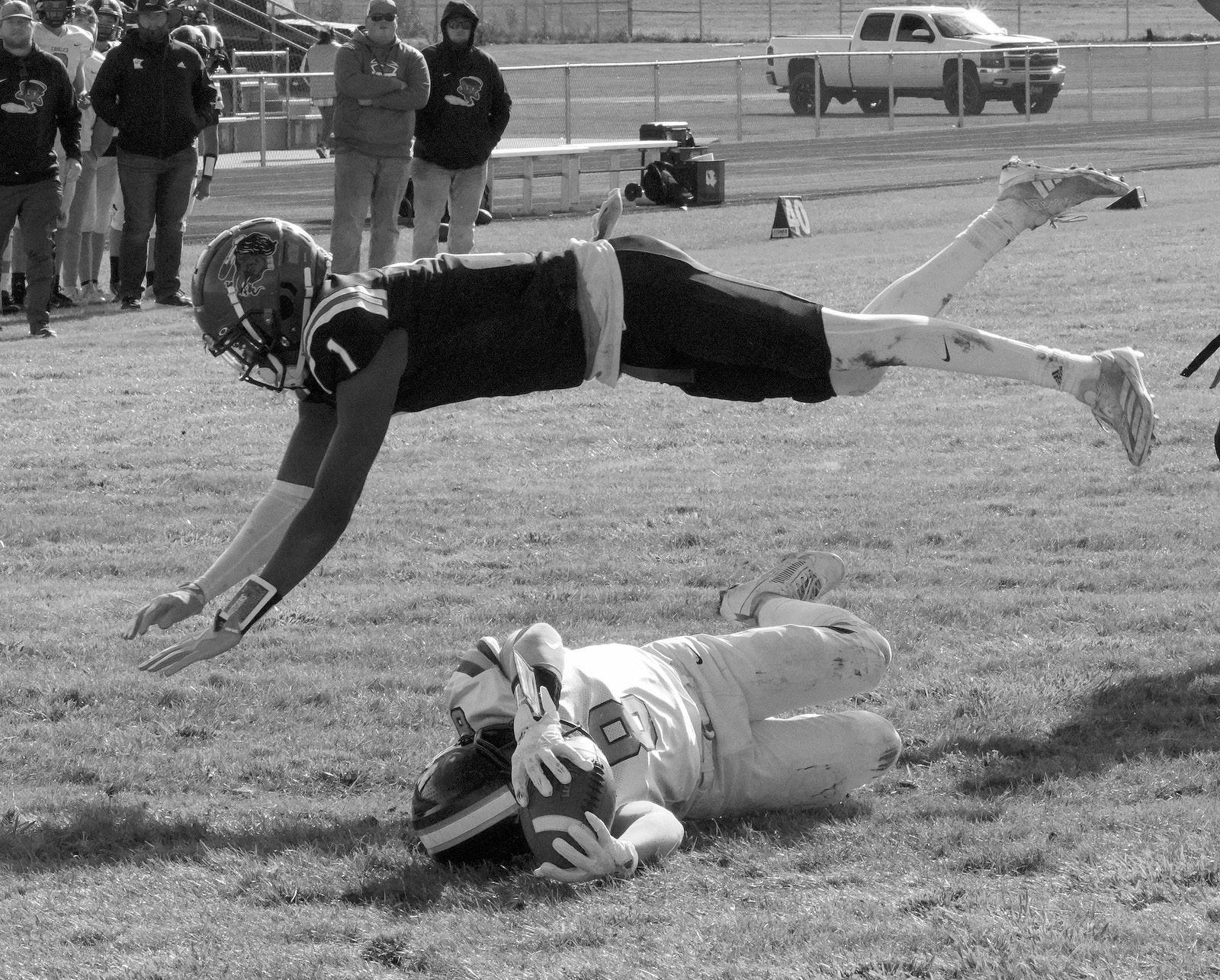 Four Wind's Marial Deng dives over Logan Werner as he crosses the goal line for a TD in the playin game. Photo by Larry Stokke.