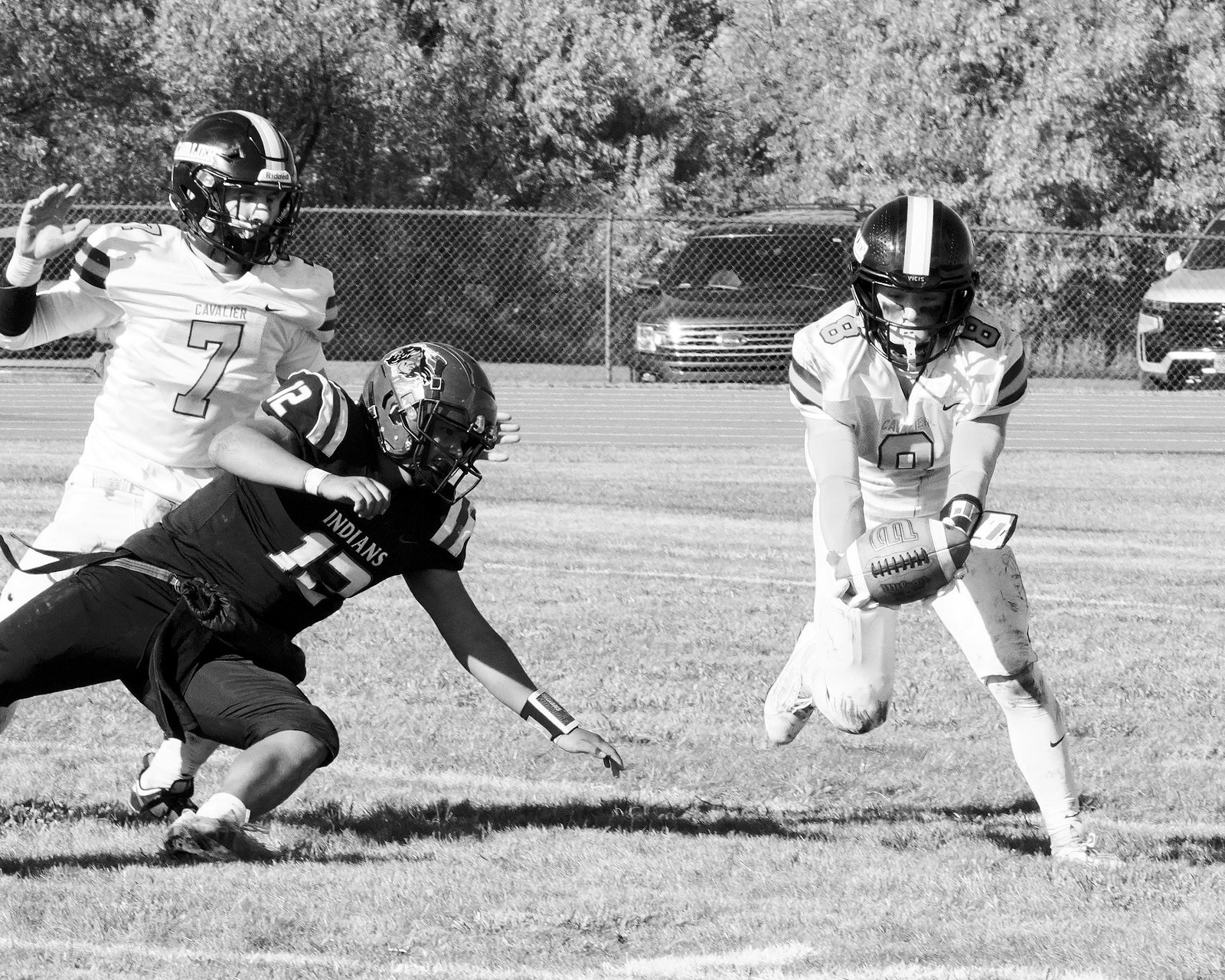 Logan Werner catches a bobbled ball for an interception and turnover for Cavalier. Photo by Larry Stokke.