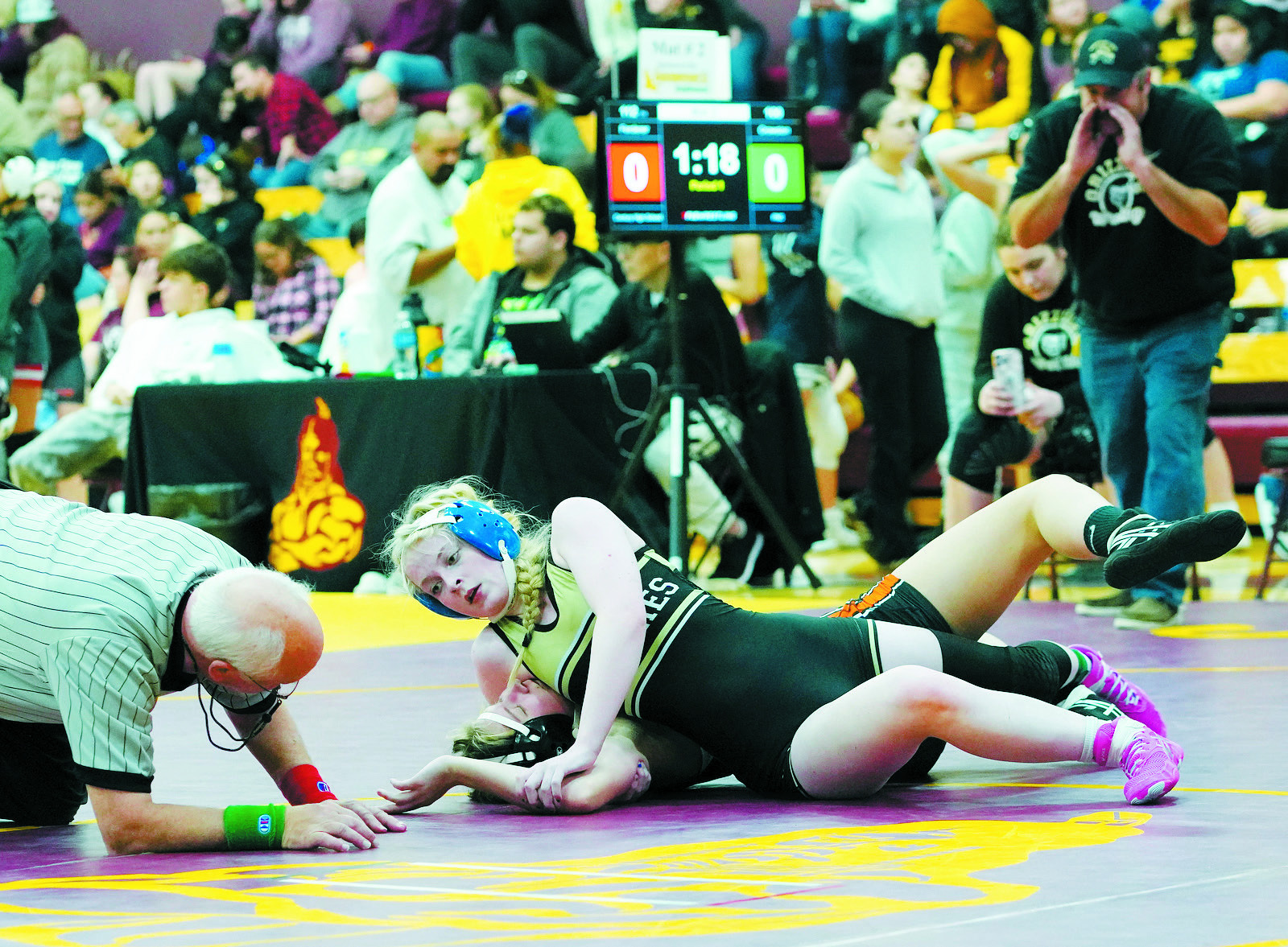 Tia Huguley pins her opponent at the Belcourt Invitational on Dec. 7. Photo by Larry Stokke.
