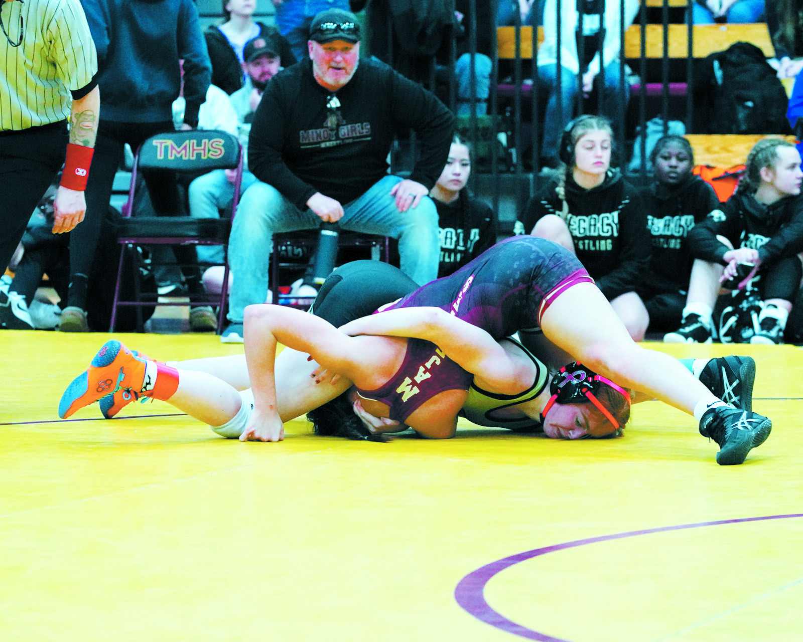 Marlie Stremick twists her opponent into a pin, winning her match. Photo by Larry Stokke.