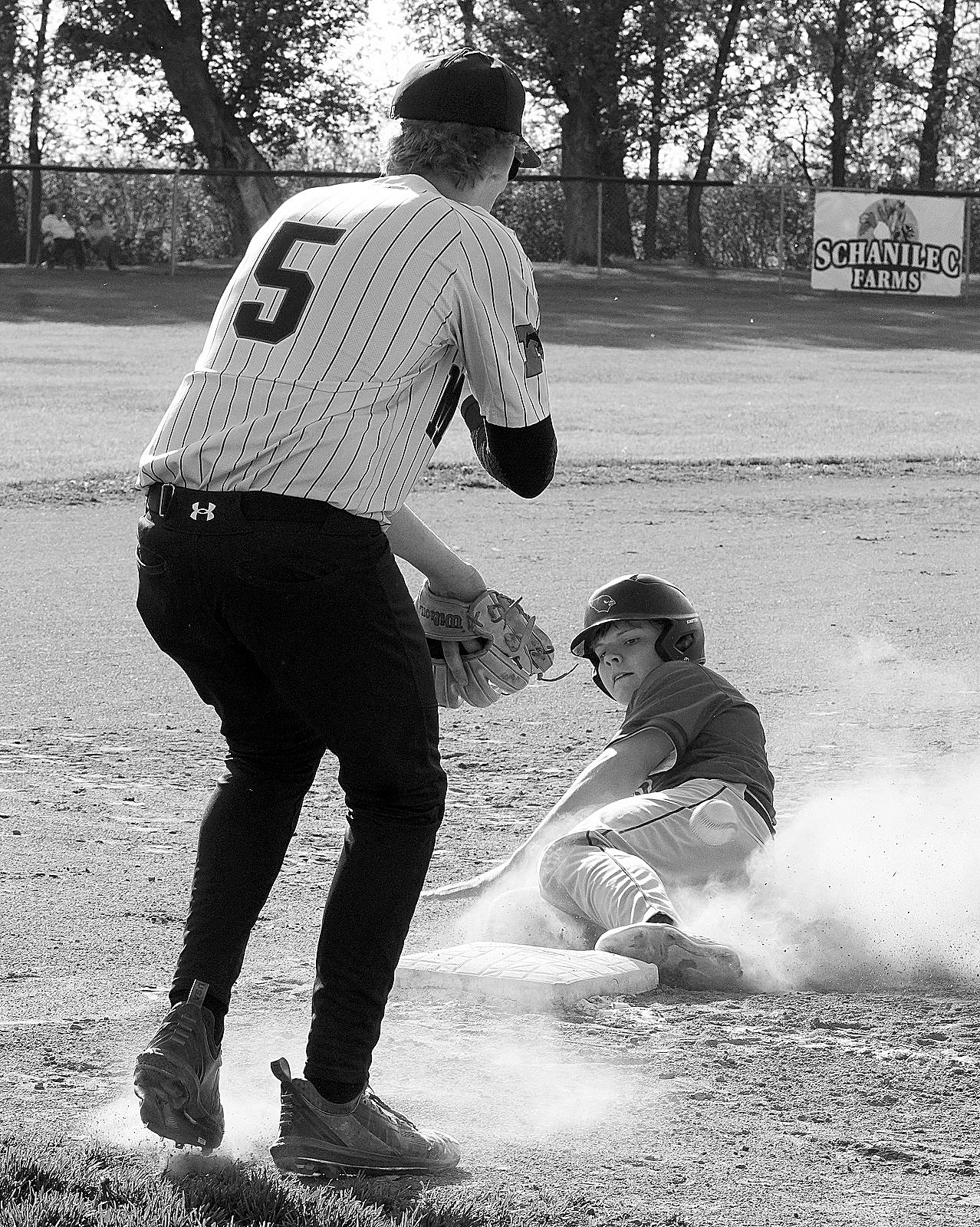 Colten Hein outruns the ball to 3rd base against Midway-Minto. Photo by Larry Stokke.