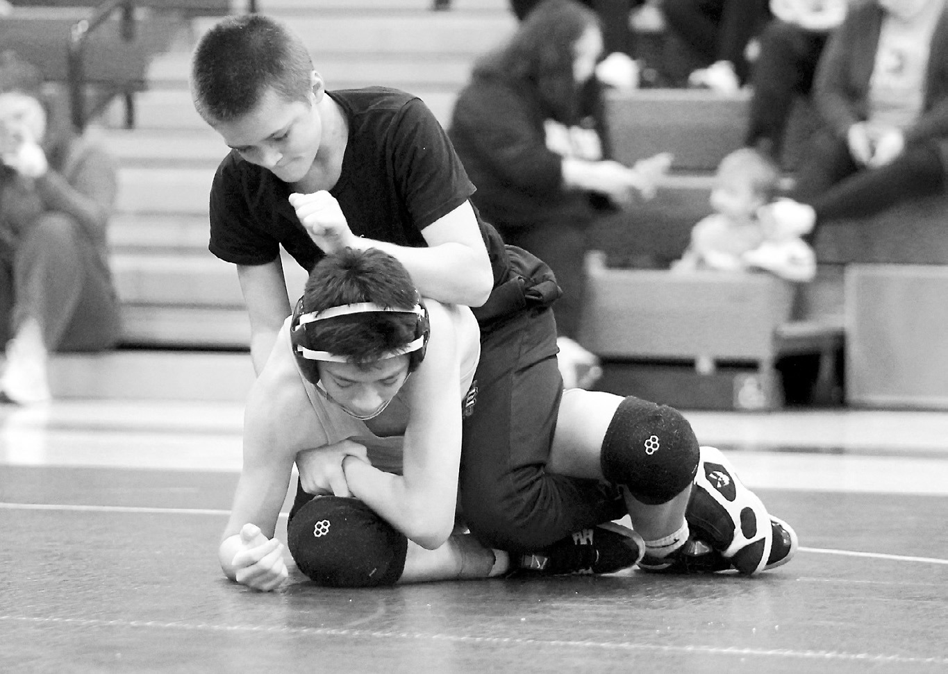 Johnny Robinson wrestled in the preseason scrimmage in Grand Forks on Nov. 15 in the 114-pound weight class. Photo by Larry Stokke.