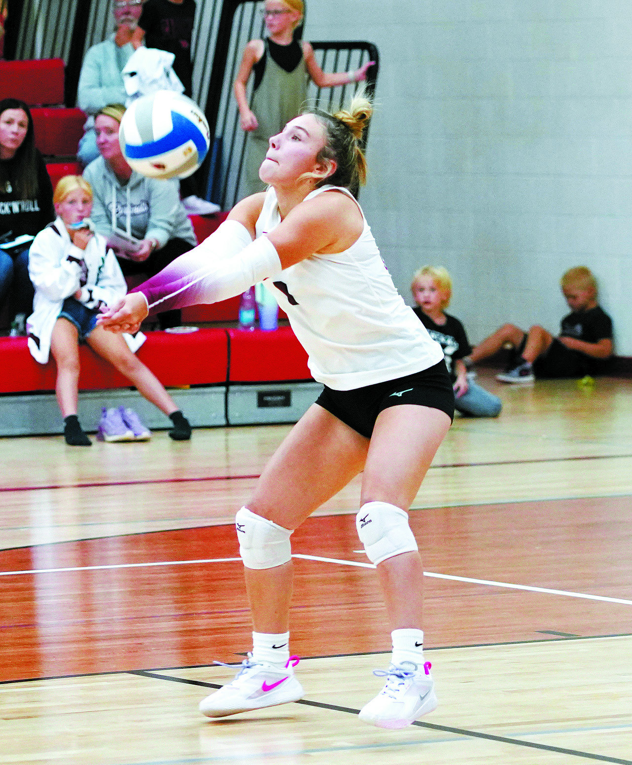 Raeleigh Ratzlaff digs the ball from the back row in the battle between Cavalier. Photo by Larry Stokke.
