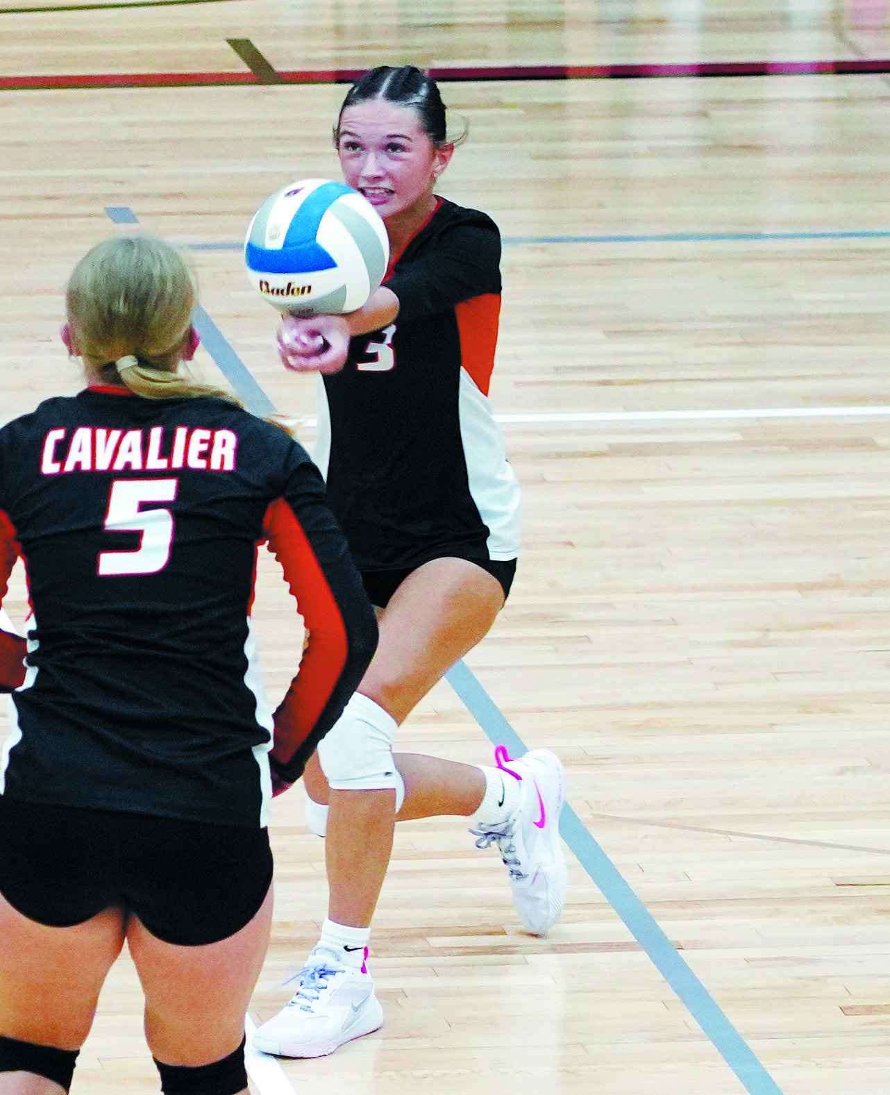 Addi Manley passes the ball to a teammate against Langdon. Photo by Larry Stokke.