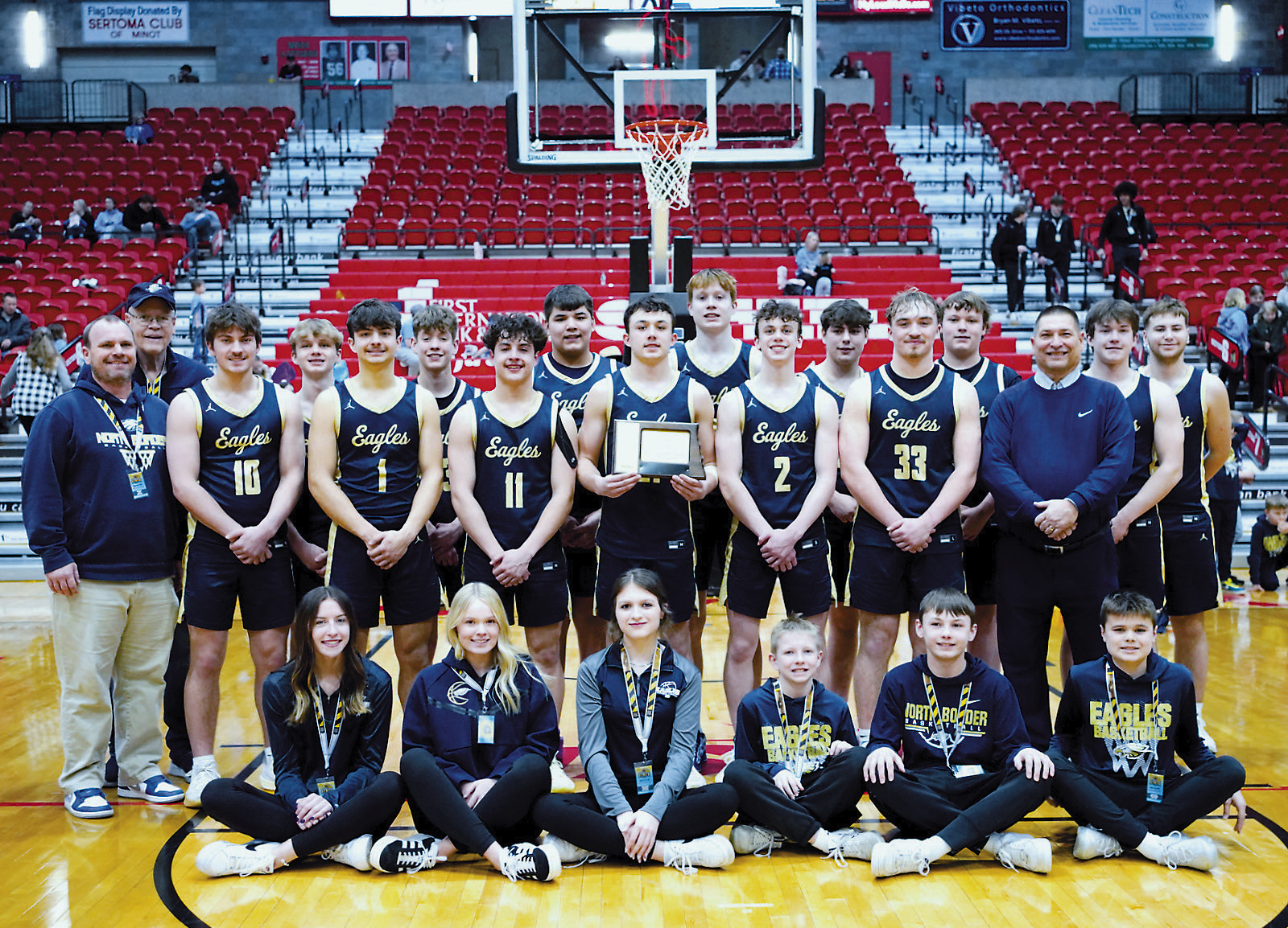 The North Border Eagles 2024-2025 boys basketball team with their 7th place trophy from the State B Tournament in Minot. Photo by Larry Stokke.