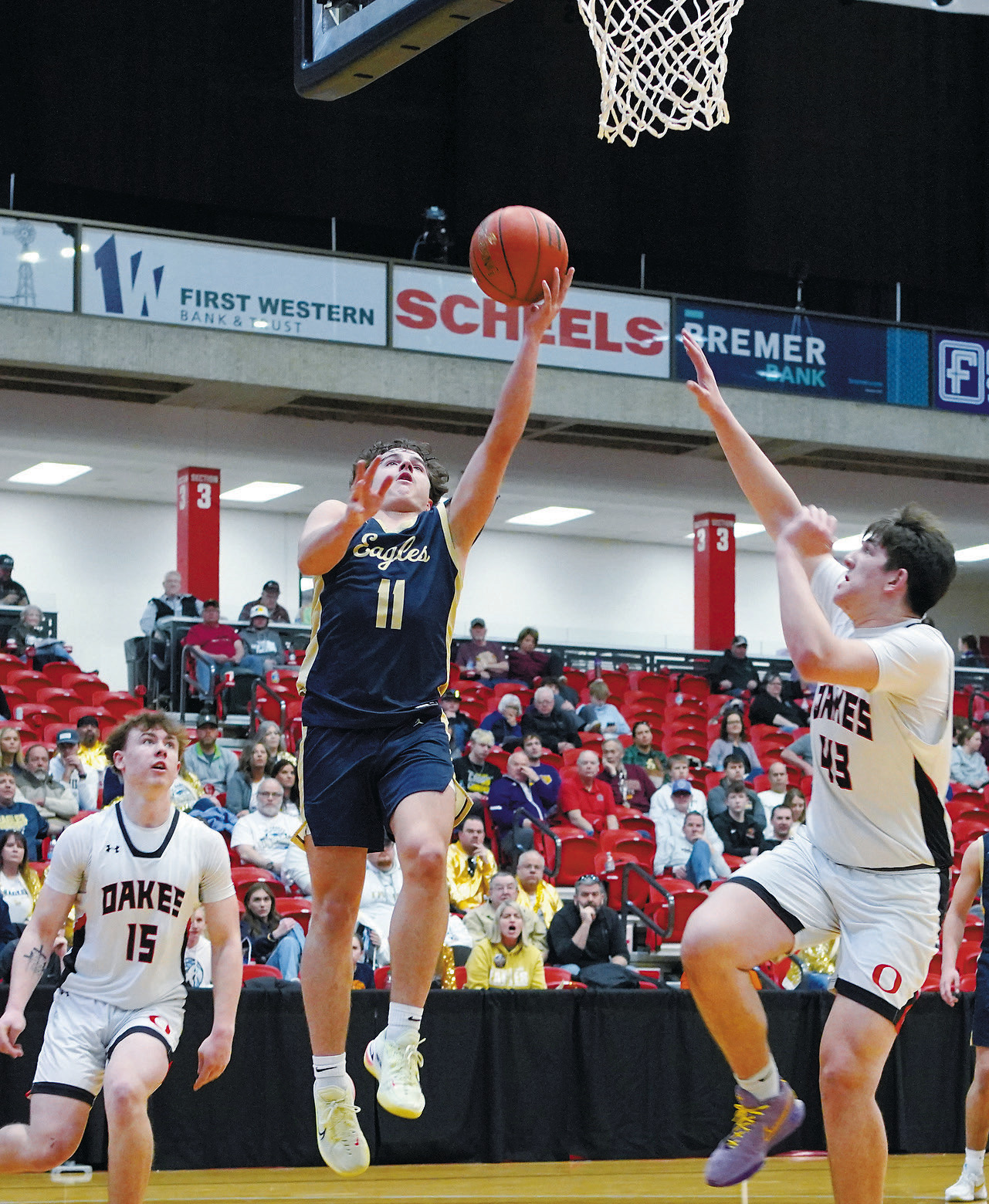 Player of the Game against Oakes, Grant Cosley, lays a basket in to finish with 12 points. Photo by Larry Stokke.