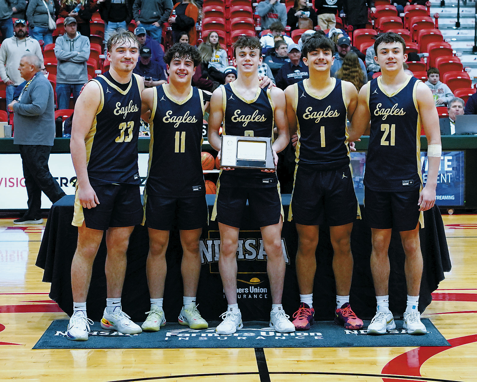The Eagles pose with their 7th place Trophy. Photo by Larry Stokke.