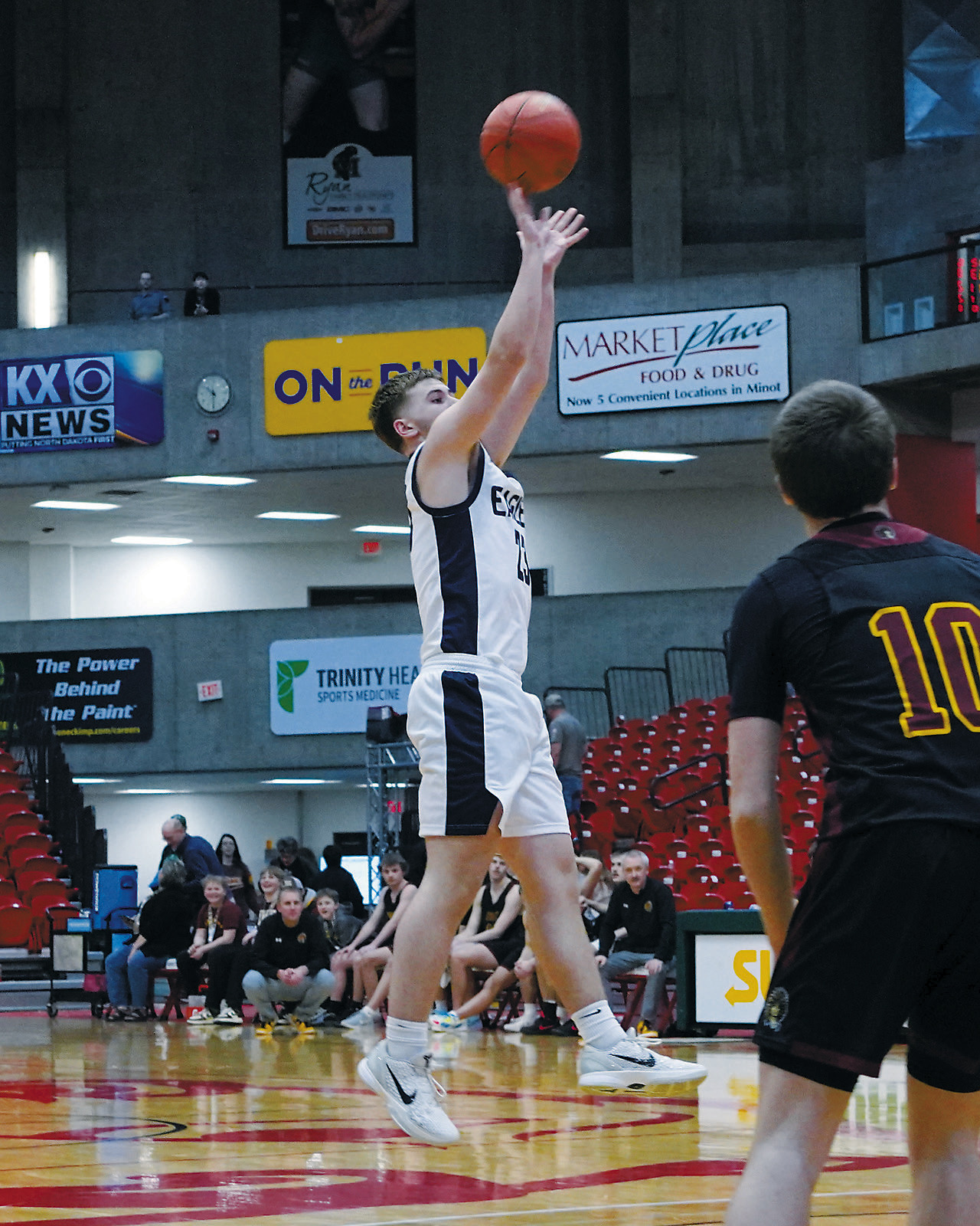 Preston Emerson drops one in the hoop for 3 points against Westhope/Newburg at the state tourney. Photo by Larry Stokke.