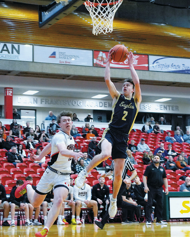 Kaden Moore drops in a layup, finishing the game with a team high of 22 points in the double OT win over Oakes for 7th place in the state tournament. Photo by Larry Stokke.