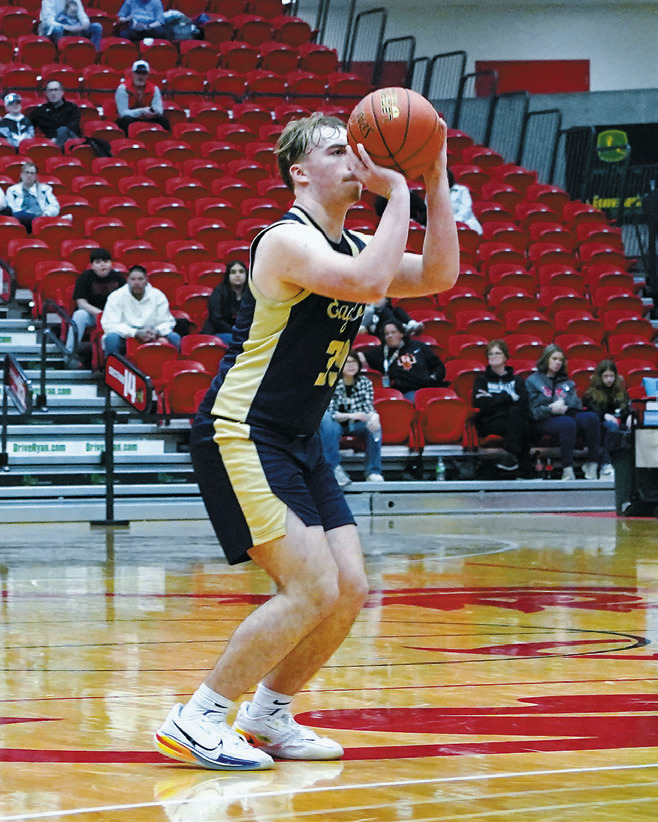 Kade Schafer steps back and drains a nothingbutnet 3-point shot, totaling 11 points in the double OT win over Oakes. Photo by Larry Stokke.