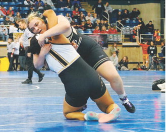 Jaelyn Forrey takes her opponent to her back, pinning her. She went on to place second at State. Photo by Larry Stokke