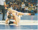 Tia Huguley powers her girl onto the mat and won by decision. Photo by Larry Stokke