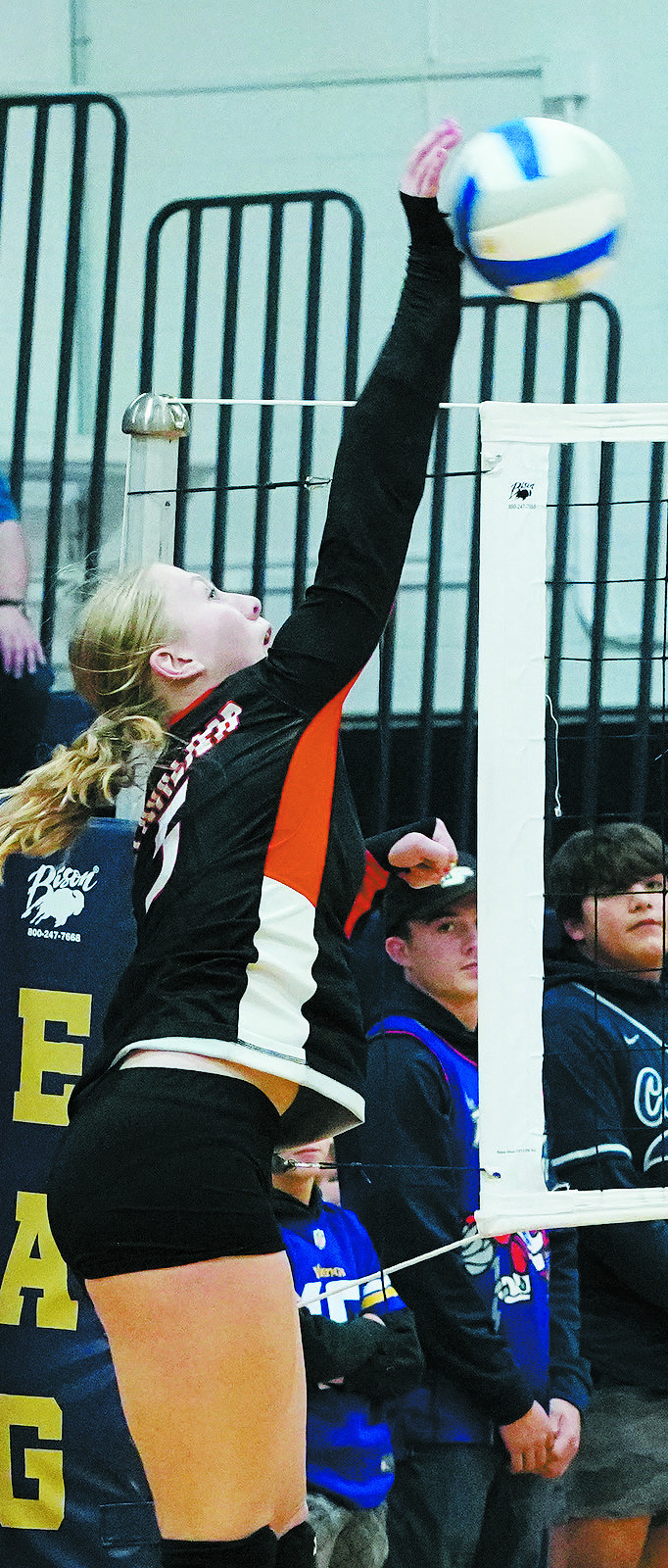 Katy Jensen hammers down a kill. Photo by Larry Stokke.