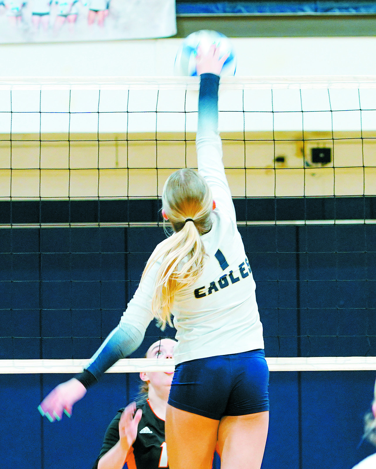 Caylee Berg with one of her 6 kills against the Cavalier Tornadoes. Photo by Larry Stokke.