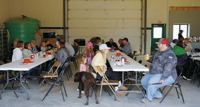 Guests enjoy their meals at last Saturday's Mud Fest fundraiser. Photo by Larry Stokke.
