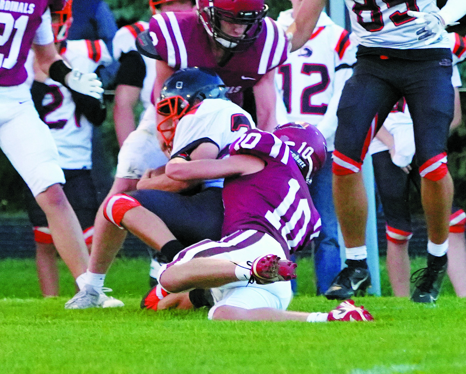 Maddux Stremick tackles a Rugby player for a turnover in downs. Photo by Larry Stokke.