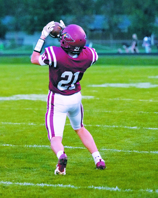 Eastyn Schaefer with a 24-yard reception in the Cards win over Rugby at their Homecoming Game. Photo by Larry Stokke.