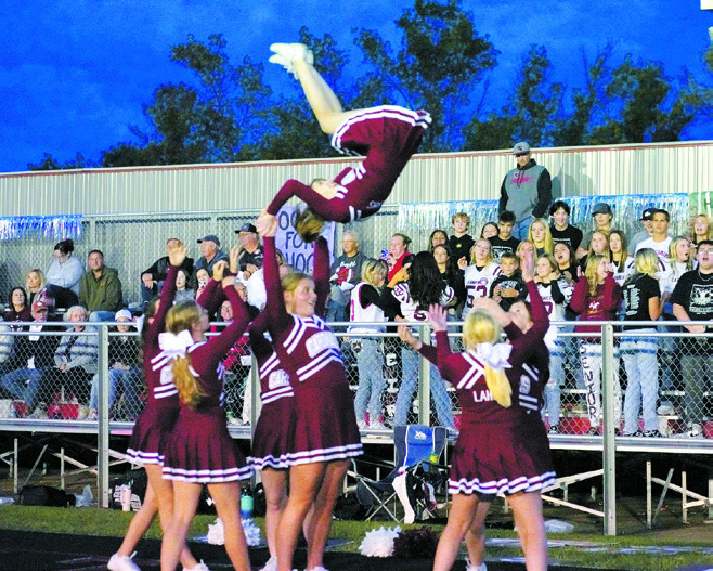 The Cardinal cheerleaders keeping fans entertained and fired up while cheering on the boys. Photo by Larry Stokke.