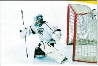 Ella Brekke blocks the puck from going past her to score. Photo by Larry Stokke.