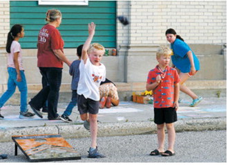 Children enjoy games and sidewalk chalk activities during the Pre-Blast Bash. Photo by Larry Stokke