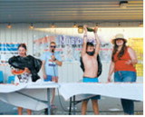 Participants raced to finish their watermelon slices during the Pre-Blast Bash watermeloneating contest as Chamber leaders cheered them on. Photo by Larry Stokke