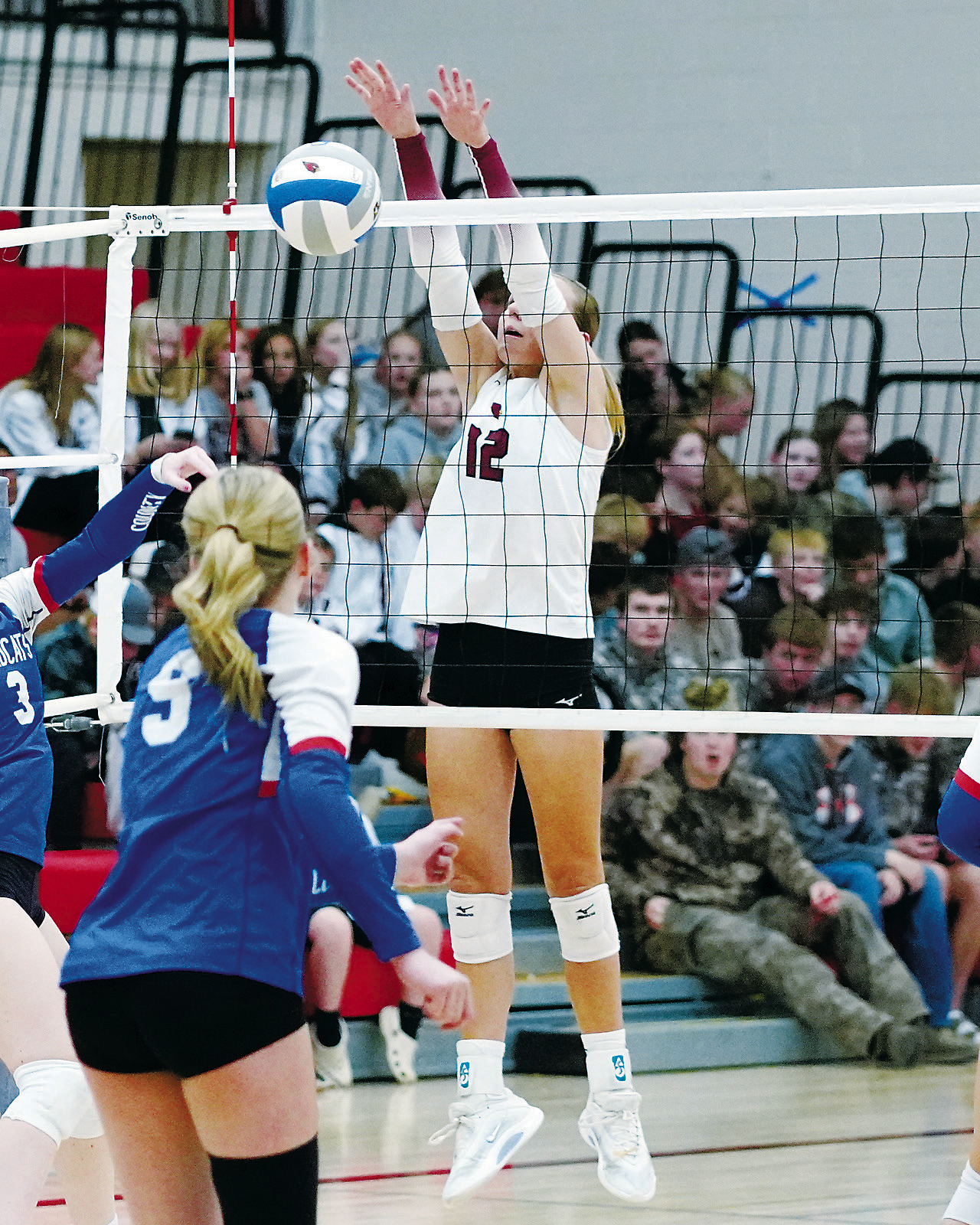 Kemi Morstad stuff blocks a Wildcat player in the Cards' sweep of a three set win on Oct. 7 in Langdon. Photo by Larry Stokke.