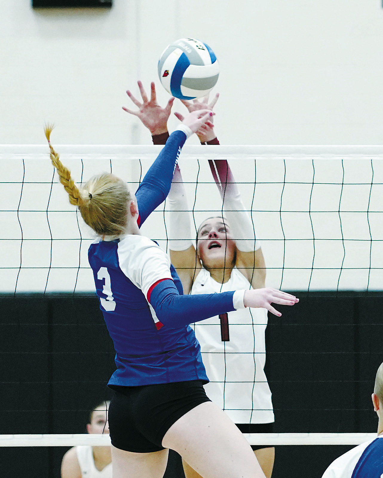 Meggy Hetletved gets up over the net and stuff blocks the ball. Photo by Larry Stokke.