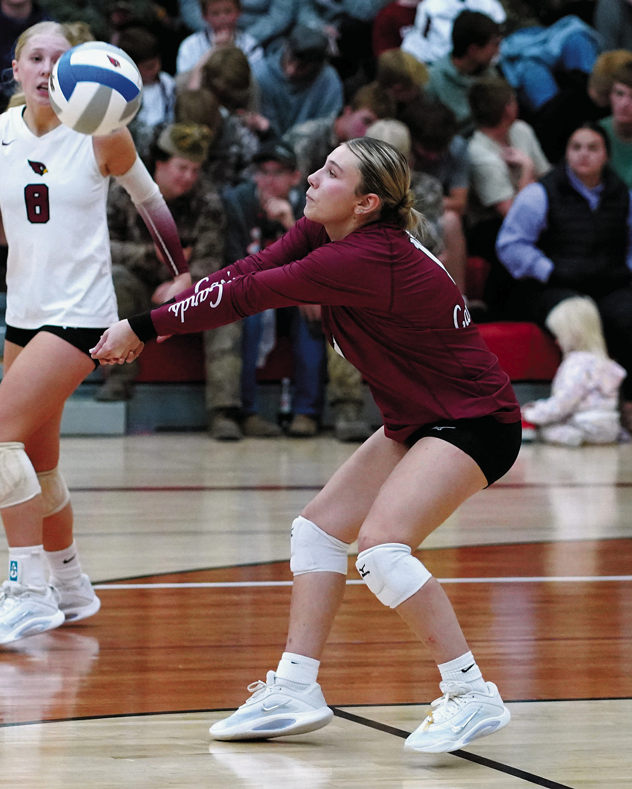 Raeleigh Ratzlaff digs the ball and sends it to the front row. Photo by Larry Stokke.