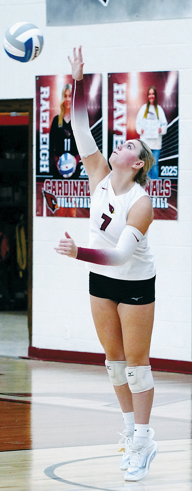 Liv Prouty eyes the ball and sends it over the net for an ace. Photo by Larry Stokke.