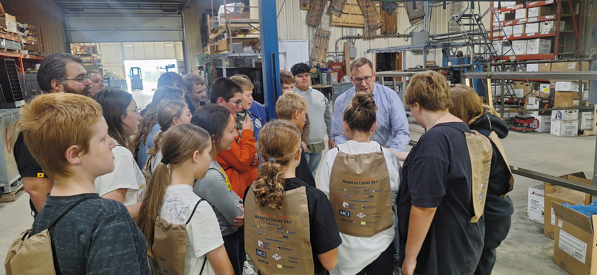 Cavalier seventh graders are shown how Bordertown Retail Systems produces custom racks for retailers.
