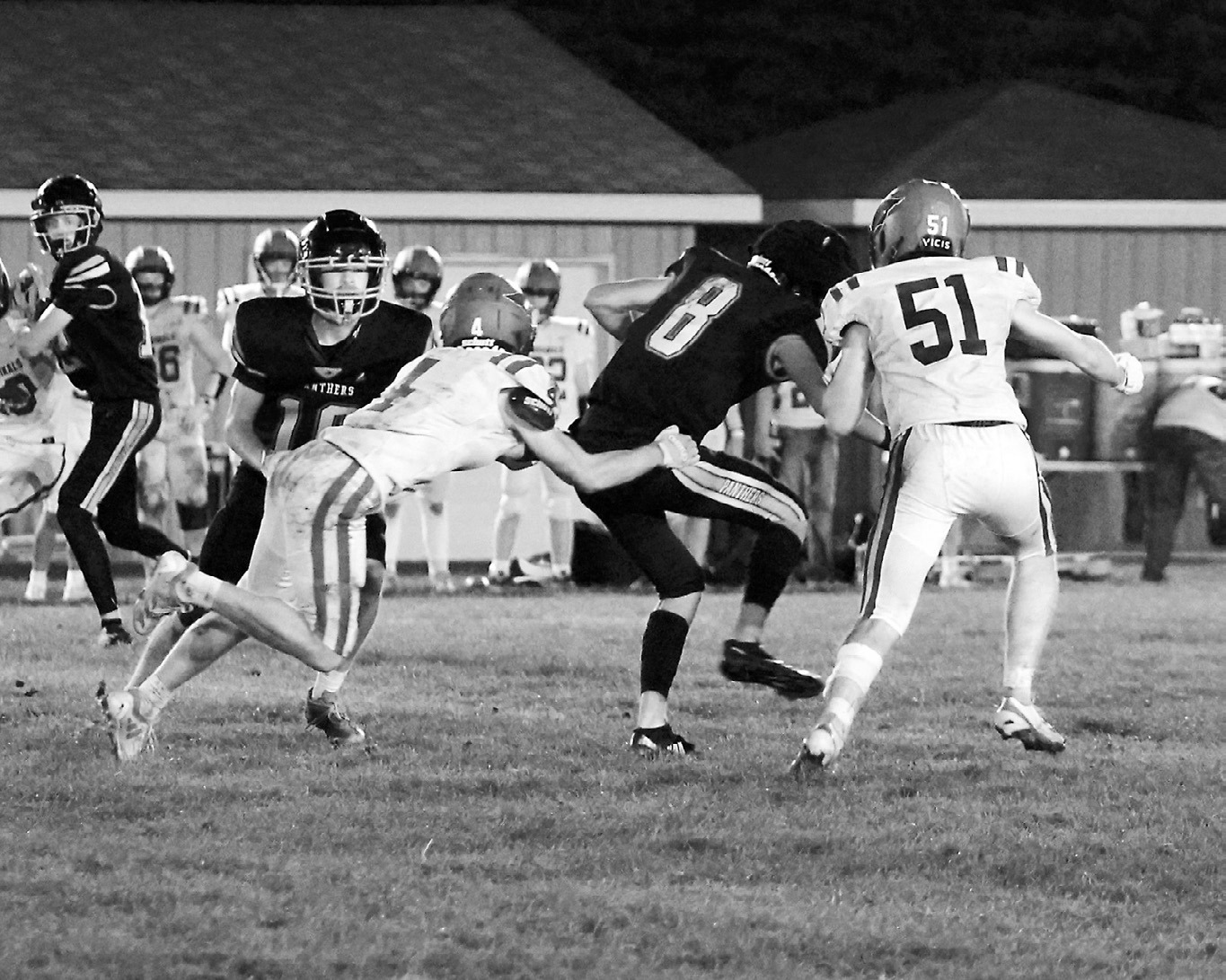 Sam Davis and Keaton Ullyott tackle Rugby Panther Kiefer Fritz in the Cardinals' win in Rugby. Photo by Larry Stokke.