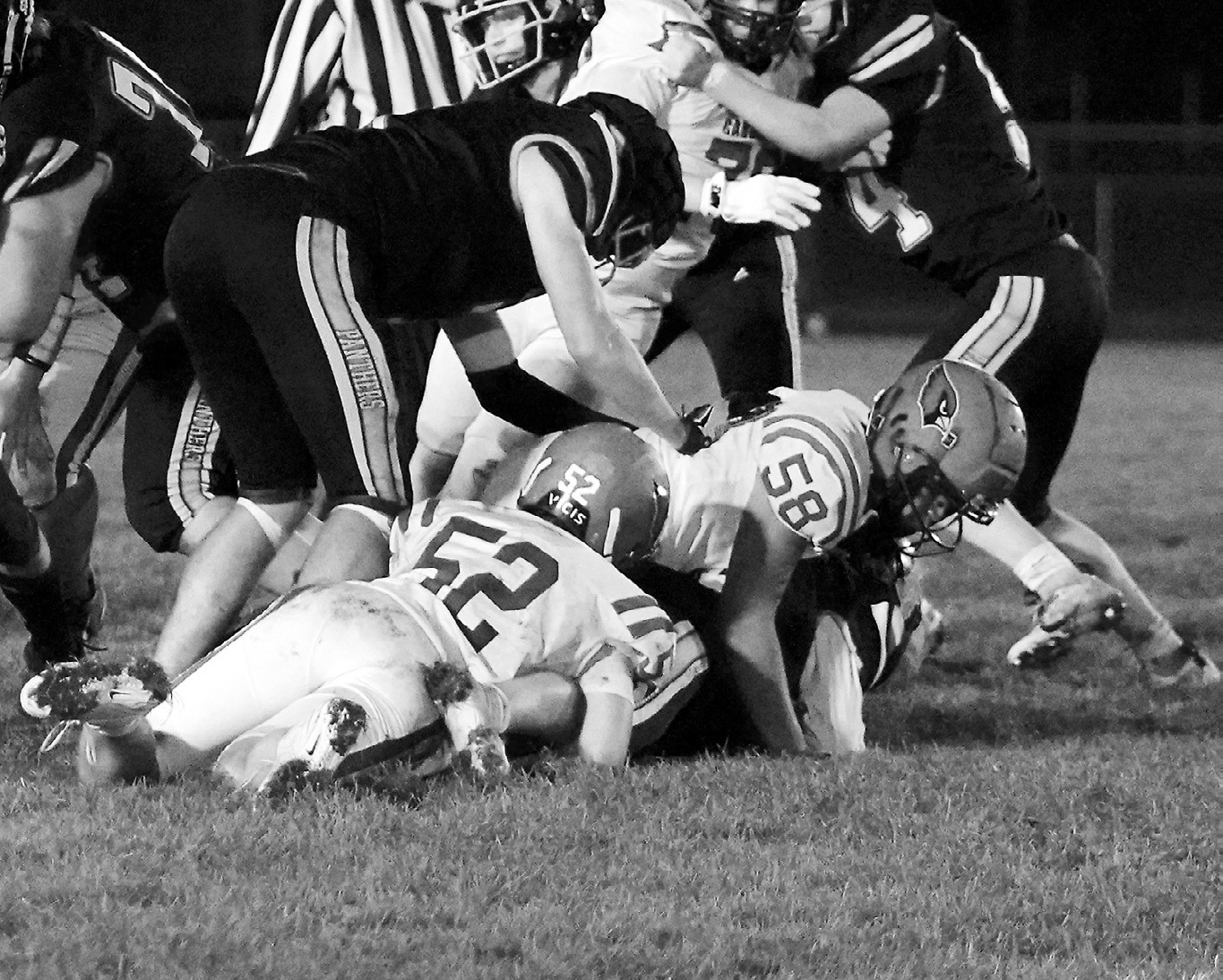 Dawson Downs and Oshun High Hawk tackle a Rugby Panther for a turnover in downs in the Cards' win in Rugby. Photo by Larry Stokke.