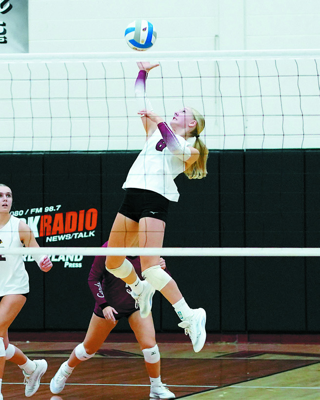 Co-Player of the Game, Hilary Haaven, sends one of her 18 kills over the net. Photo by Larry Stokke.