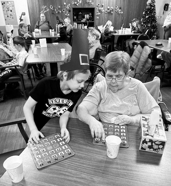 Logan and Anna Mae playing bingo.