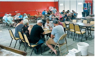 Community members gather for a meal during the Nekoma Rural Fire Department fundraiser. The annual event brings residents together while raising funds to support the department's equipment, training and emergency response efforts. Submitted photo