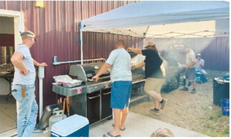 Cooks Jason Schill, Kyle Moen, Chase Heck, Josh Metzger, Blake Hipp, Billy Mitchell and Jonathan Skjervheim prepare the meal during the Nekoma Rural Fire Department fundraiser. The annual event raises funds to support the department while bringing the community together for an evening of food and fellowship. Submitted photo
