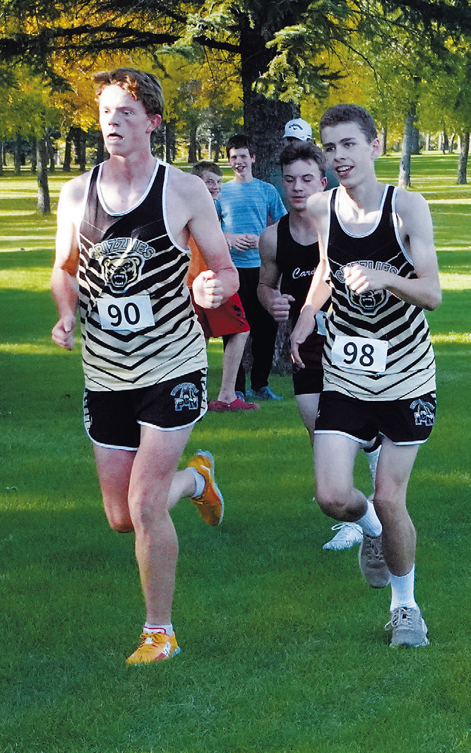 Bjorn Evenson followed by Joseph Wright make their way around the course in Langdon on Sept. 22. Photo by Larry Stokke.