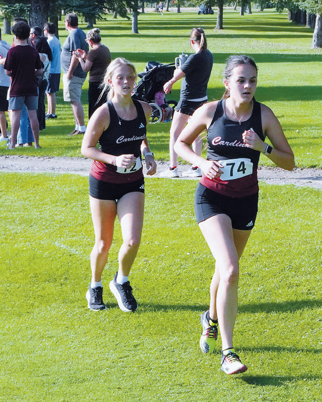 Heidi Crump followed by teammate Remmi Bodnar finished 20th and 22nd, respectively, in Langdon on Sept. 22. Photo by Larry Stokke.