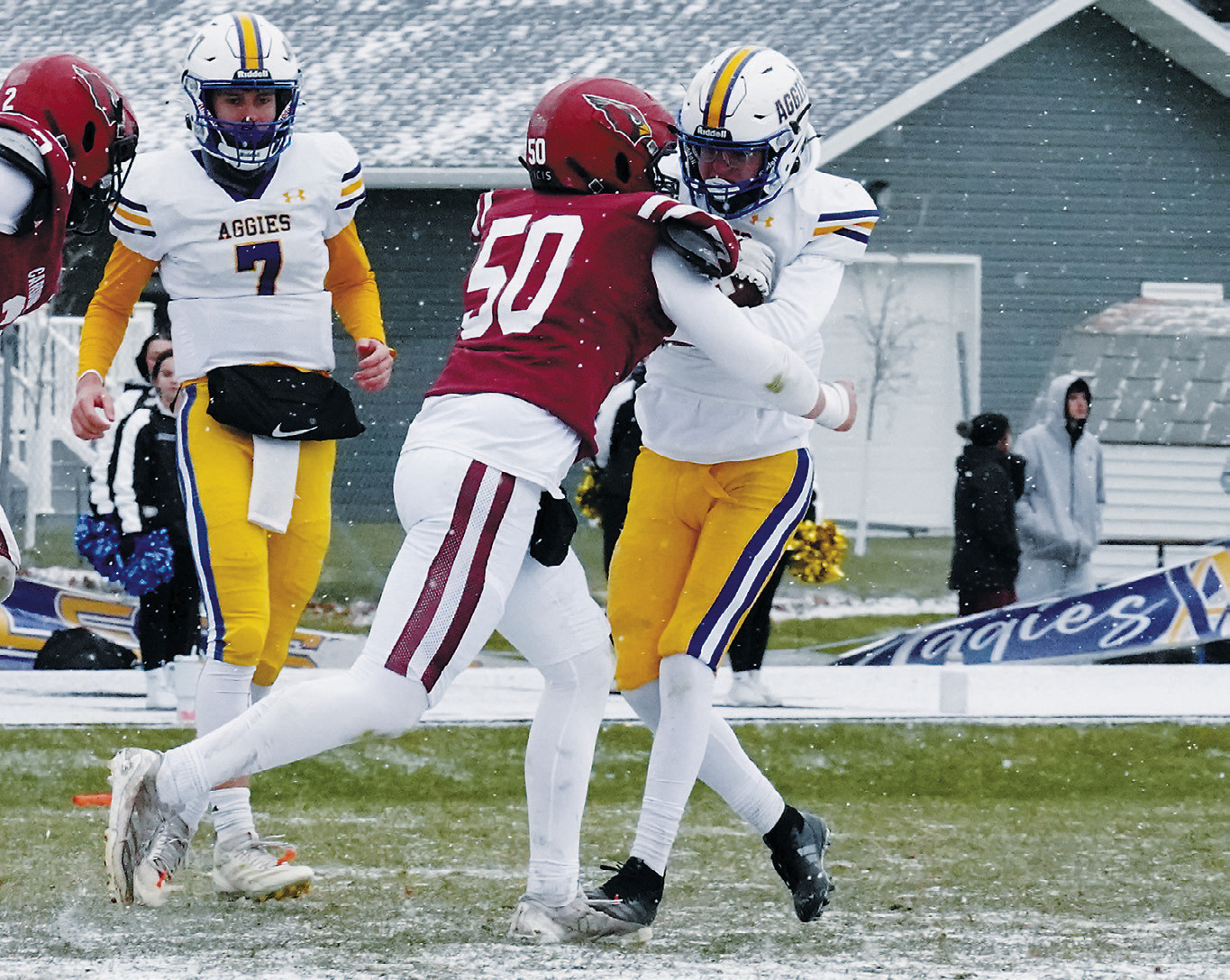 Caleb McDonald makes a diving wrap-up with help from teammates to tackle a Velva ball carrier Landon Schneider stops a Velva ballcarrier from gaining a first down. Photo by Larry Stokke. to punch their ticket to the state title game in Fargo. Photo by Larry Stokke.