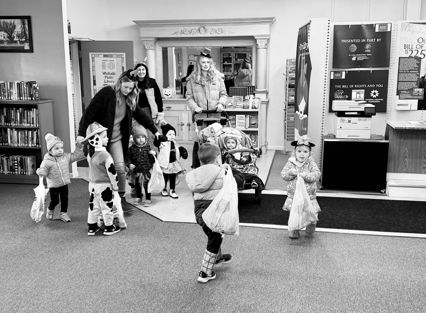 Trick or treaters visiting the library on Halloween.