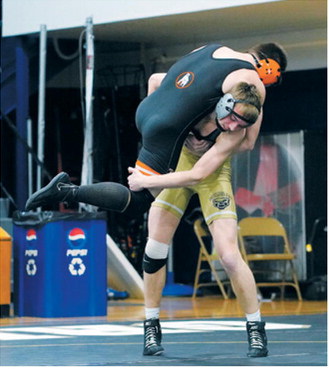 Oakley Brown powers his opponent off the mat and pins him in 17 seconds. Photo by Larry Stokke