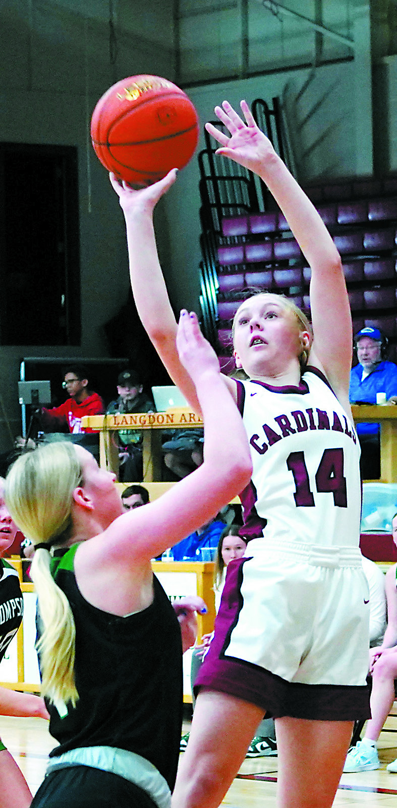 Hilary Haaven puts up a shot over a Thompson Tommie to add two points to the Cards’ score. Photo by Larry Stokke.