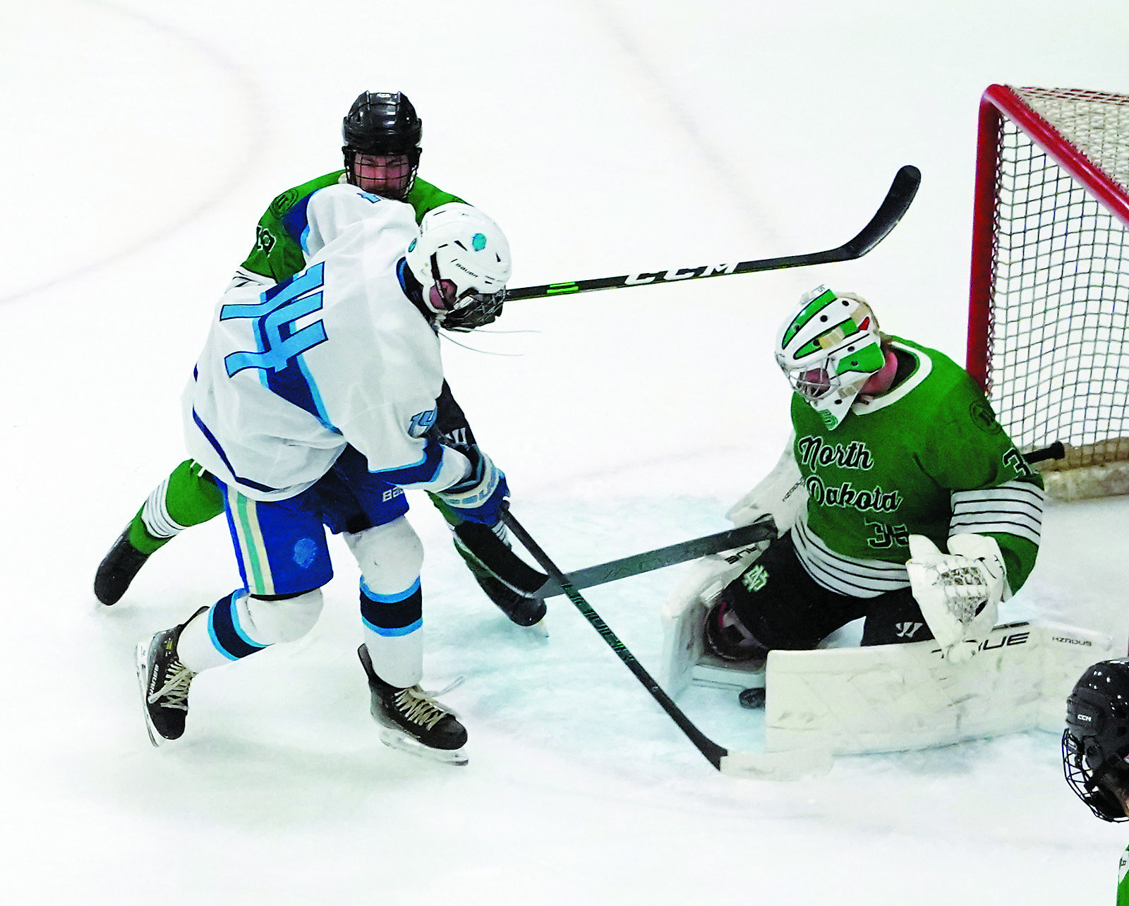 Brody Steinmetz attacks the net but has his shot blocked by the UND goalie. Photo by Larry Stokke.