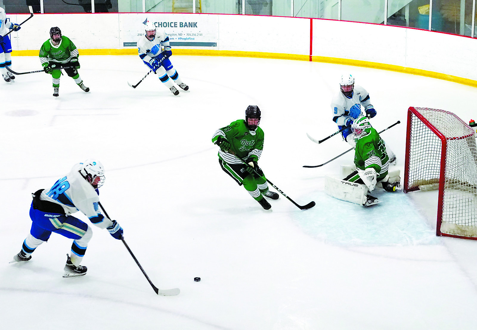 Alex Gellner sends the puck past the UND goalie to add a second point for the Royals. Photo by Larry Stokke.