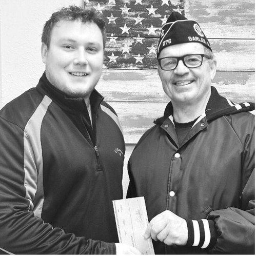 Xavier Mitchell of Horizon Financial Bank presents a check to Kevin Dawley of the Sarles American Legion. The $500 donation is from Horizon Financial Bank and its board of directors.