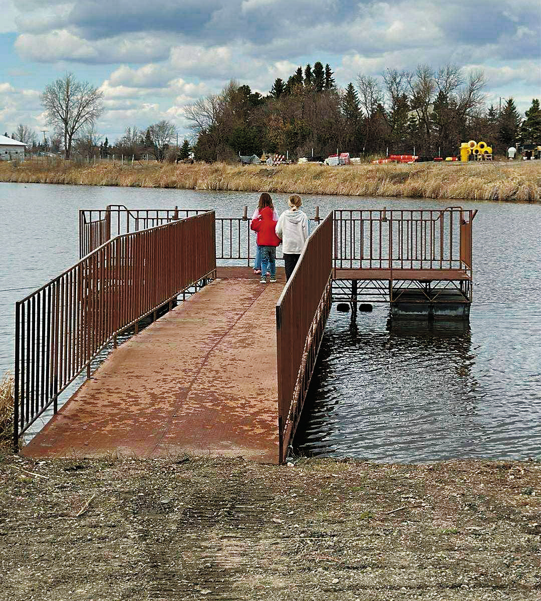 Holden and Zowie Kreklau enjoying the fishing pier at the Langdon City Pond.