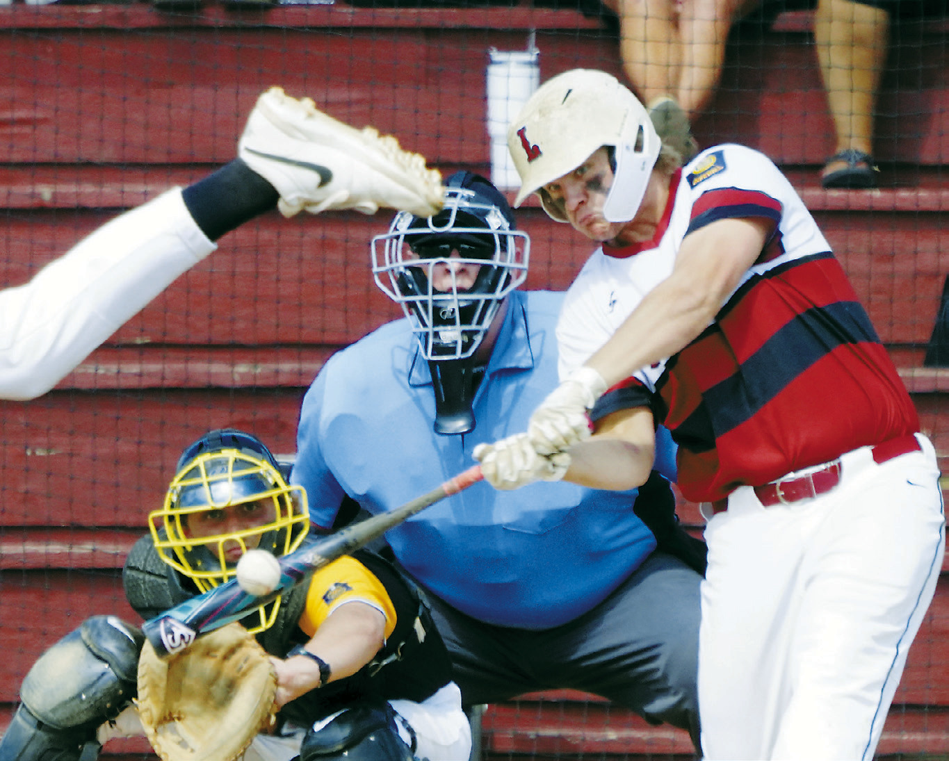 Theo Romfo connects for a base hit against Park River on July 21. Photo by Larry Stokke.