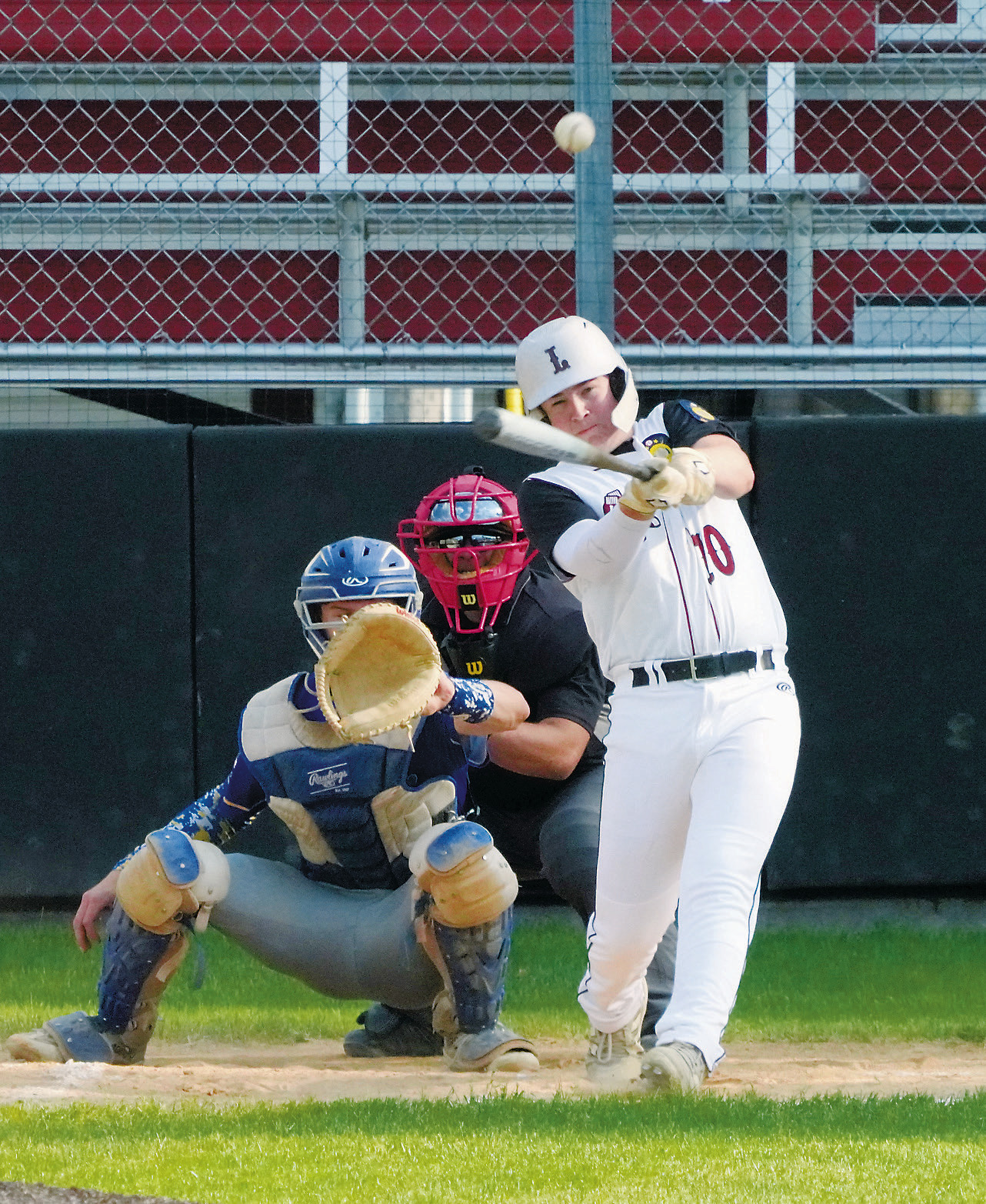 Devin Hakanson drives the ball into the outfield against Hatton/Northwood. Photo by Larry Stokke.