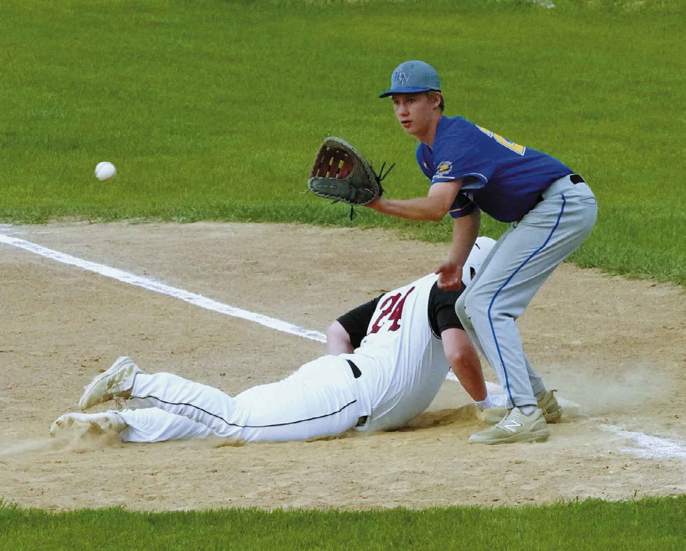 Cole Welsh gets back to first base safely, beating the ball to the first baseman. Photo by Larry Stokke.